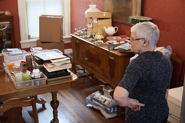 Photo of woman contemplating a mess to organize